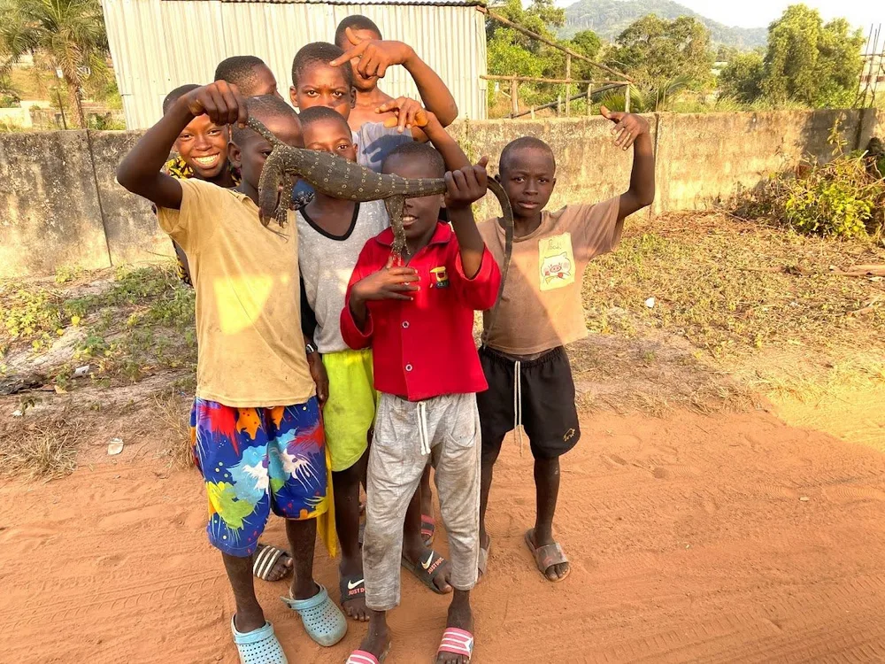 Children smiling and holding up the day's catch